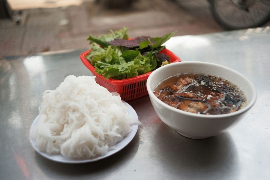 Bún chả with noodles, herbs and sauce.